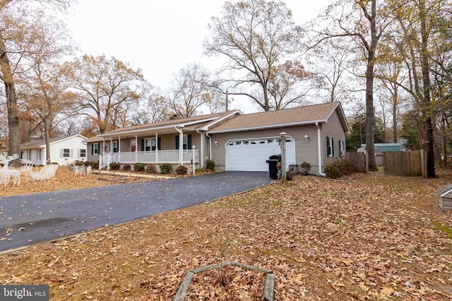 ranch-style home with a porch and a garage