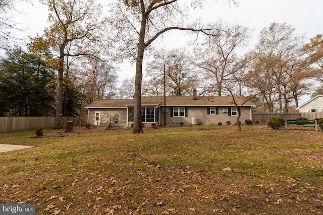 back of house with a lawn