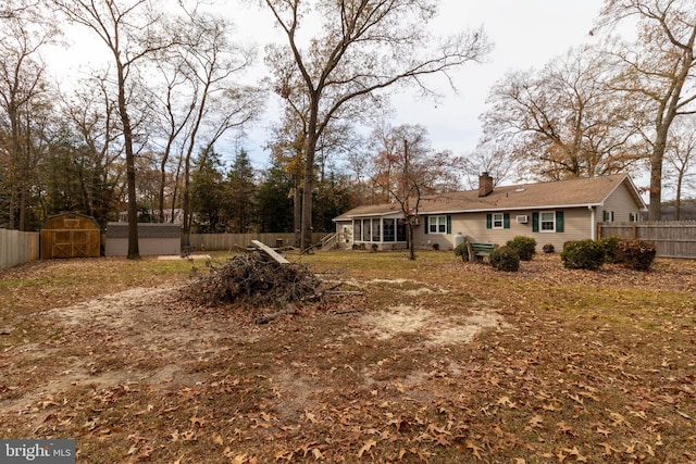 view of yard featuring a storage shed and a sunroom