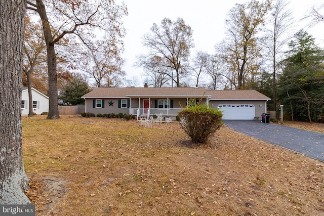 ranch-style home with a porch and a garage