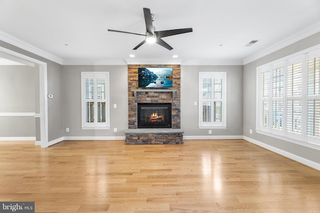 unfurnished living room with a fireplace, ceiling fan, light wood-type flooring, and crown molding