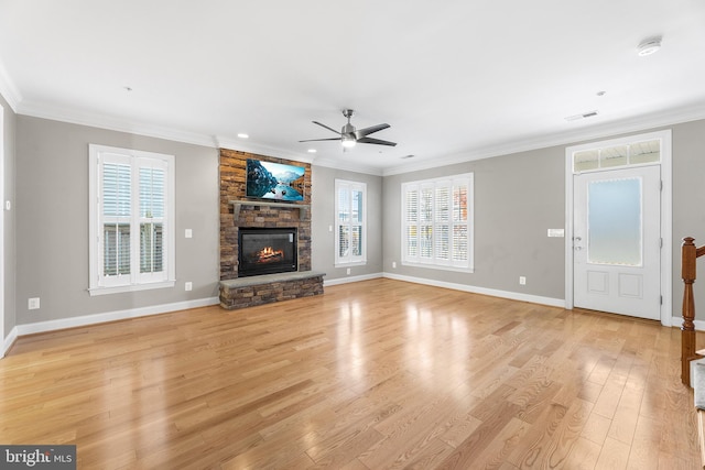 unfurnished living room featuring crown molding, a fireplace, and light wood-type flooring