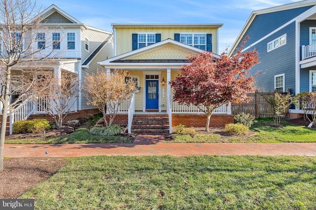 view of front of property with covered porch and a front yard