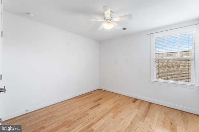 spare room with ceiling fan and light wood-type flooring