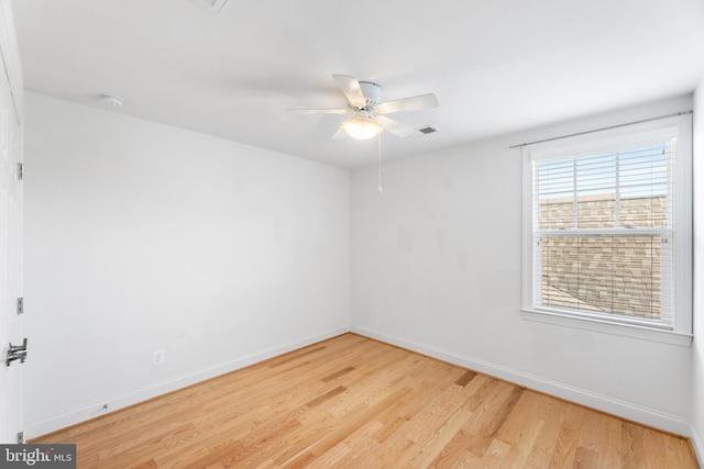 empty room featuring ceiling fan and light wood-type flooring