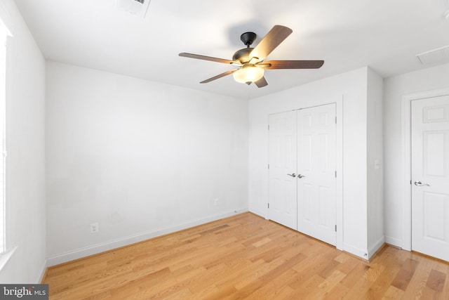 unfurnished bedroom featuring a closet, light hardwood / wood-style floors, and ceiling fan