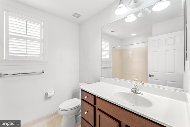 bathroom with walk in shower, vanity, and toilet