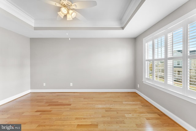 spare room featuring a healthy amount of sunlight, light wood-type flooring, and ornamental molding