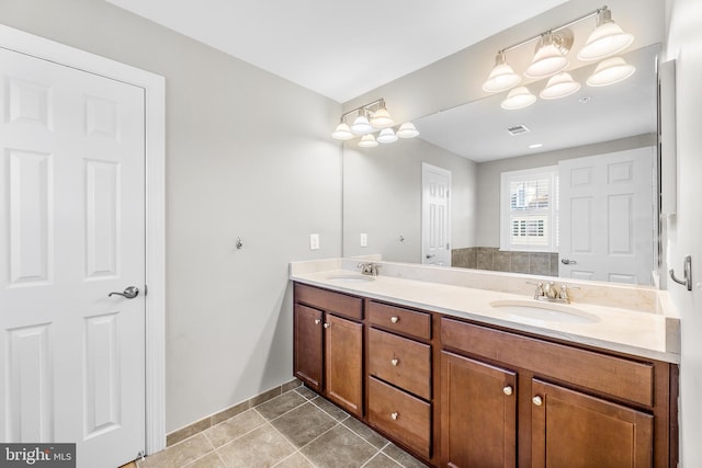 bathroom with tile patterned floors and vanity