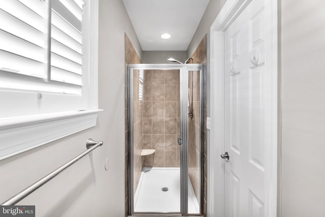 bathroom with a shower with shower door