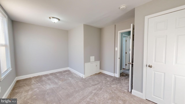 empty room featuring light carpet