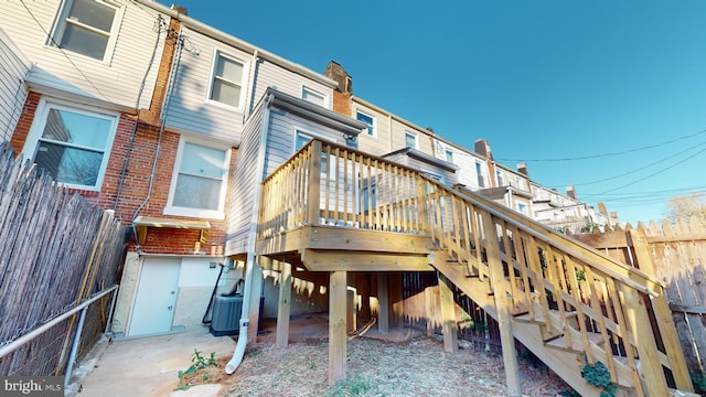 back of house featuring central AC and a wooden deck