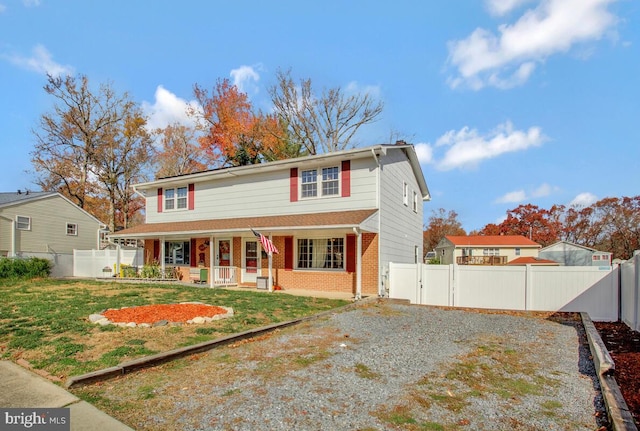 view of front of property with a front yard and a porch