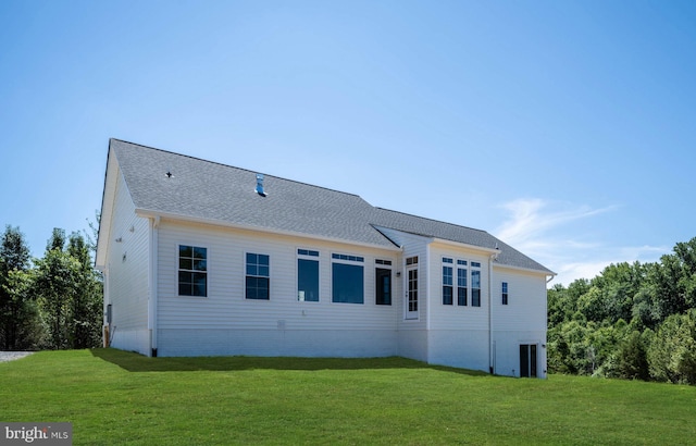 back of property featuring a lawn