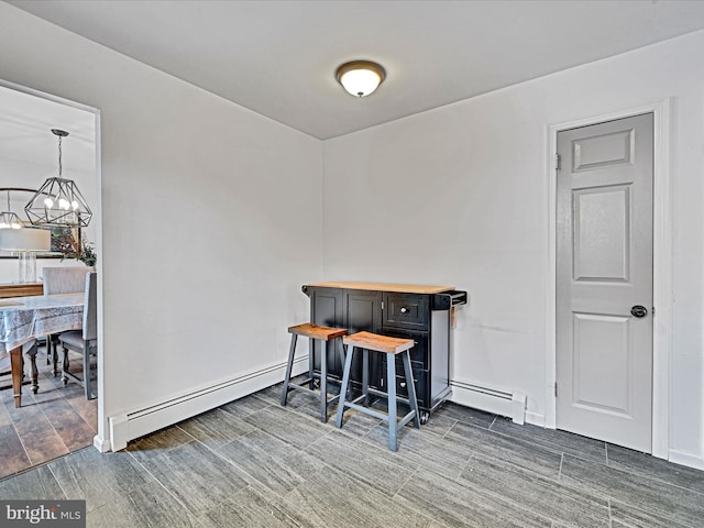 office with baseboard heating, dark wood-type flooring, and a notable chandelier