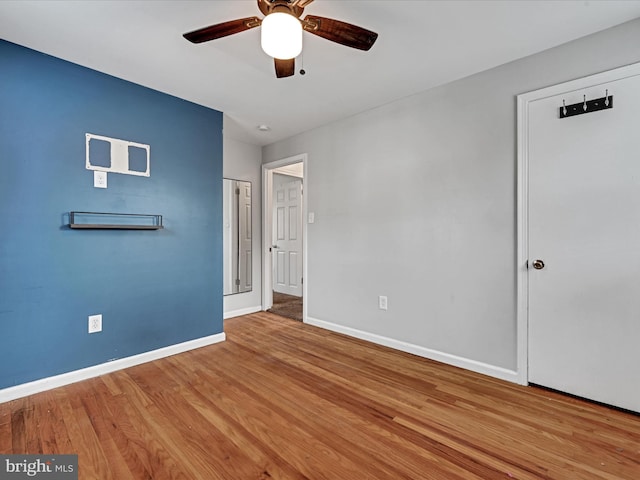 unfurnished bedroom featuring hardwood / wood-style flooring and ceiling fan