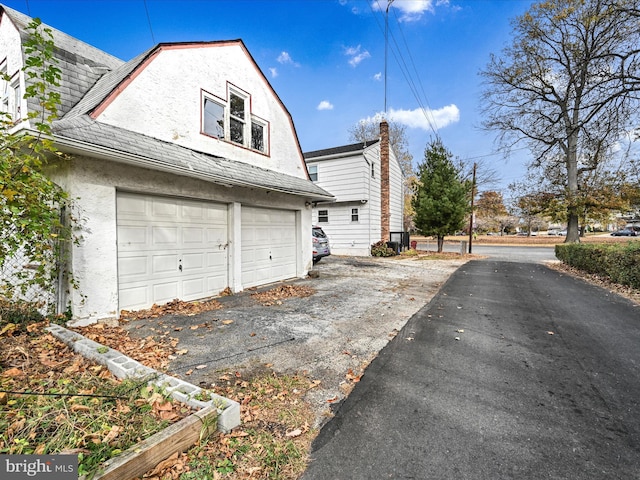 view of property exterior with a garage