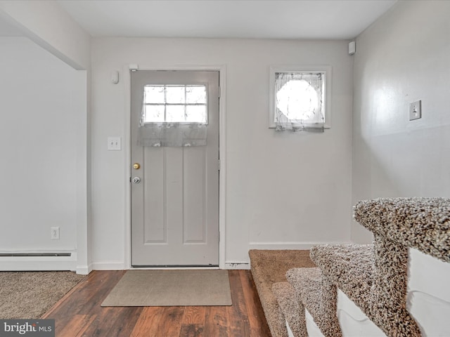 foyer entrance featuring dark hardwood / wood-style floors and baseboard heating