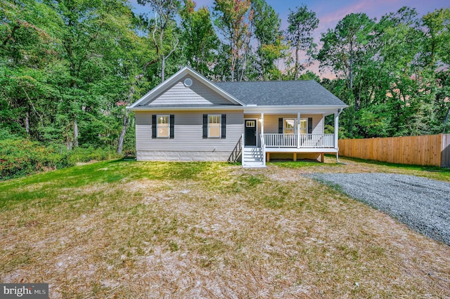 view of front facade with a lawn and covered porch