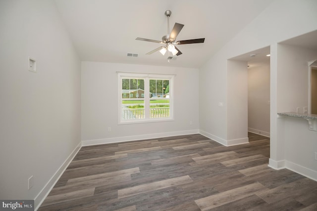 unfurnished room featuring ceiling fan, dark hardwood / wood-style flooring, and vaulted ceiling