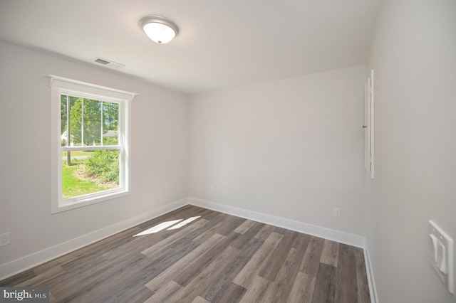 spare room featuring dark hardwood / wood-style flooring