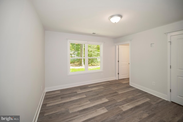 spare room with dark hardwood / wood-style flooring