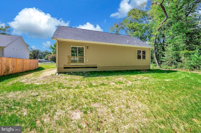 rear view of property with a yard