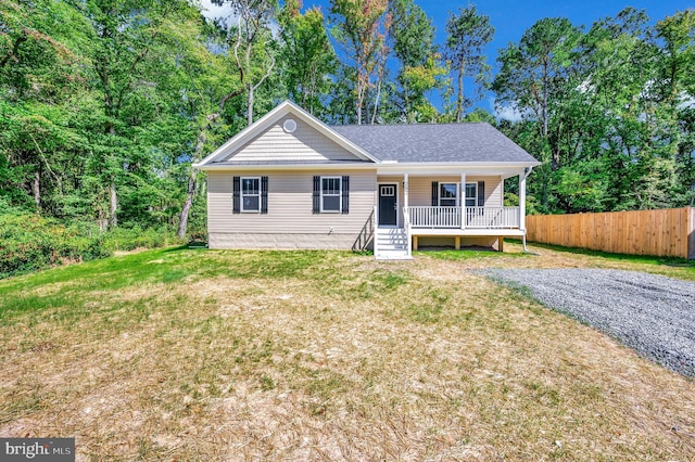 view of front of property with covered porch and a front lawn