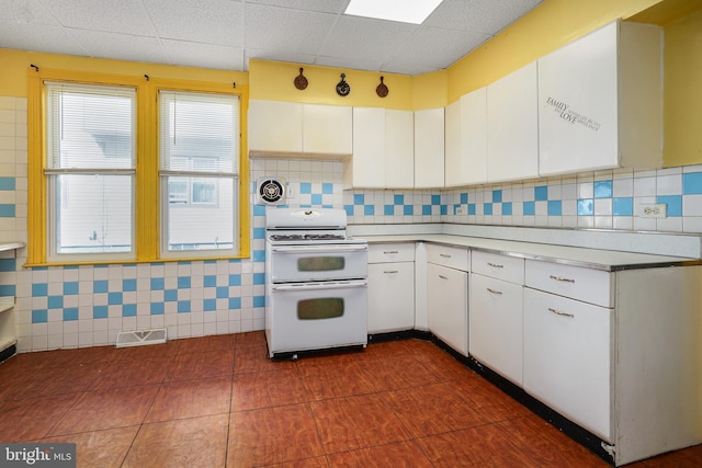 61 Belmont Ave, Wilmington, DE 19804 - kitchen with double oven range, white cabinetry, light countertops, and tasteful backsplash