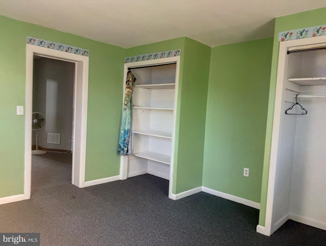 unfurnished bedroom featuring dark carpet