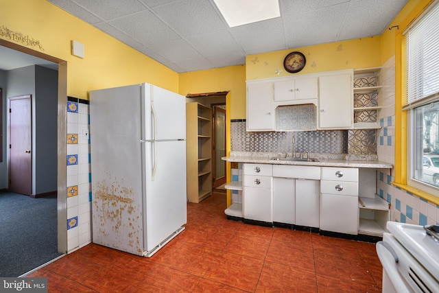 61 Belmont Ave, Wilmington, DE 19804 - kitchen with freestanding refrigerator, open shelves, a sink, range, and white cabinetry