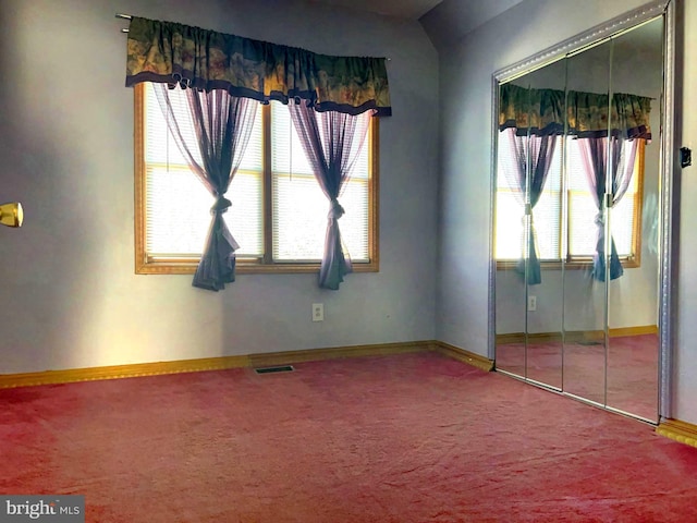 unfurnished bedroom featuring carpet flooring and a closet