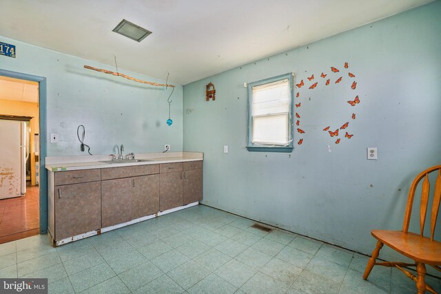 61 Belmont Ave, Wilmington, DE 19804 - kitchen featuring light floors, a sink, and light countertops
