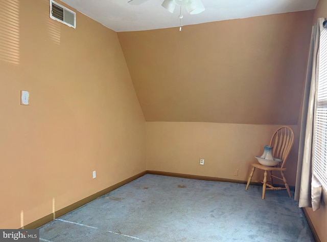 additional living space with ceiling fan, carpet floors, and lofted ceiling