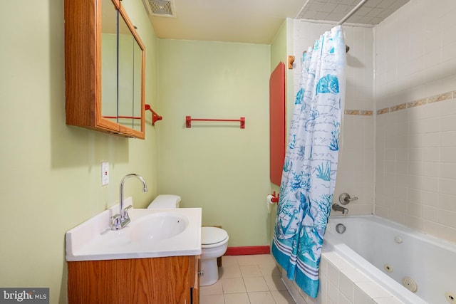 61 Belmont Ave, Wilmington, DE 19804 - full bathroom featuring tile patterned flooring, toilet, a combined bath / shower with jetted tub, vanity, and baseboards