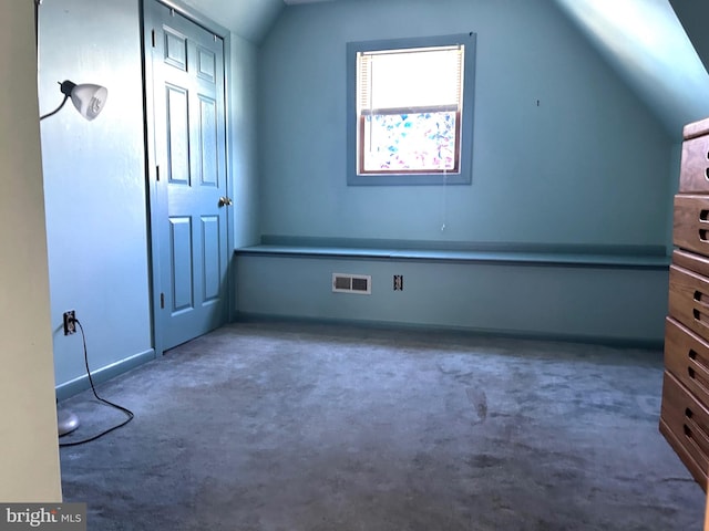 bonus room with carpet floors and vaulted ceiling