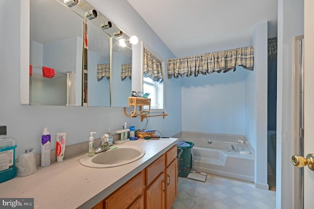 bathroom featuring vanity and independent shower and bath