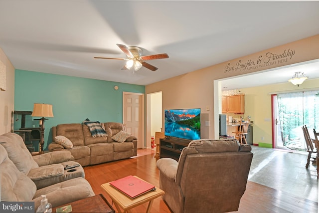 living room with ceiling fan and light hardwood / wood-style floors