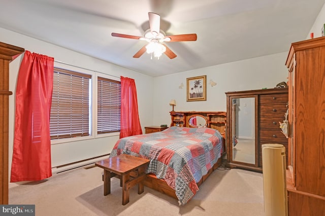 carpeted bedroom featuring ceiling fan and a baseboard heating unit