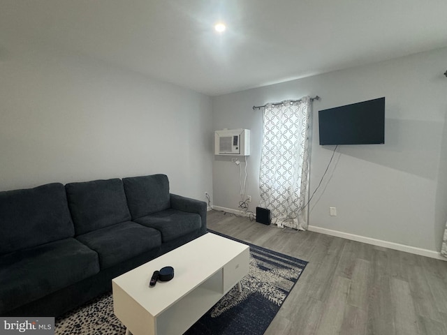 6406 Coastal Hwy Unit 201, Ocean City, MD 21842 - living room with wood finished floors, baseboards, and an AC wall unit