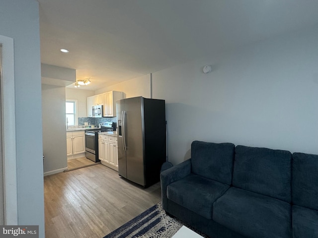 6406 Coastal Hwy Unit 201, Ocean City, MD 21842 - living area with light wood finished floors, recessed lighting, and baseboards