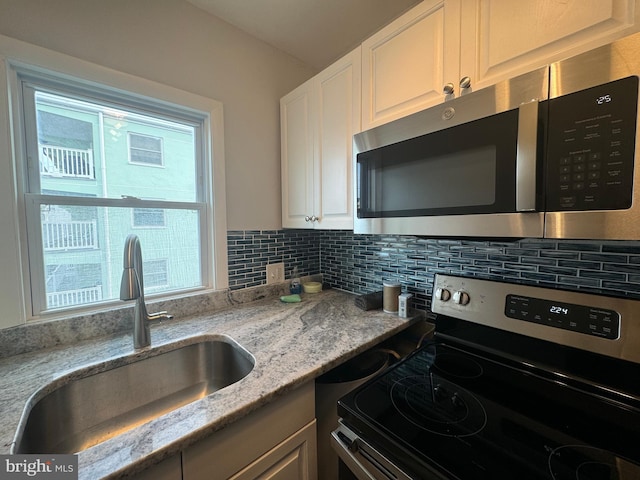 6406 Coastal Hwy Unit 201, Ocean City, MD 21842 - kitchen featuring appliances with stainless steel finishes, a sink, plenty of natural light, and backsplash