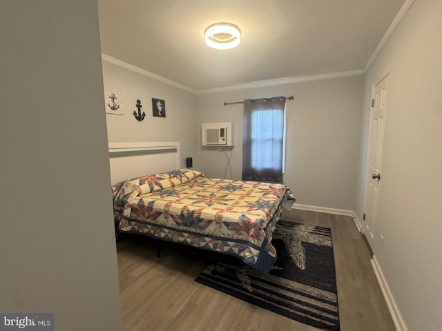 6406 Coastal Hwy Unit 201, Ocean City, MD 21842 - bedroom featuring ornamental molding, wood finished floors, a wall unit AC, and baseboards