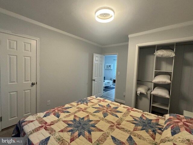 unfurnished bedroom with a closet and ornamental molding