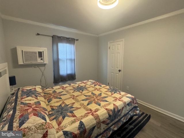 6406 Coastal Hwy Unit 201, Ocean City, MD 21842 - bedroom with an AC wall unit, dark wood-type flooring, ornamental molding, and baseboards