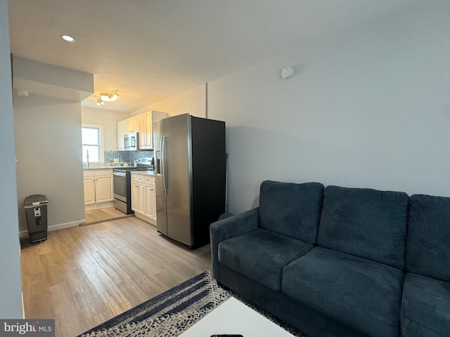 6406 Coastal Hwy Unit 201, Ocean City, MD 21842 - living area featuring light wood finished floors and baseboards