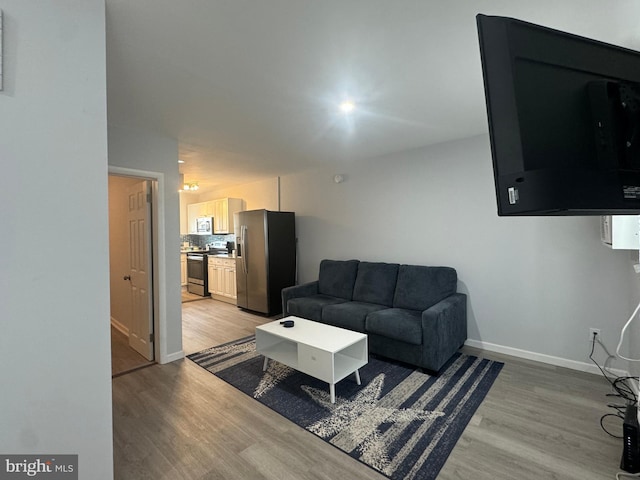 6406 Coastal Hwy Unit 201, Ocean City, MD 21842 - living room featuring light wood-style flooring and baseboards