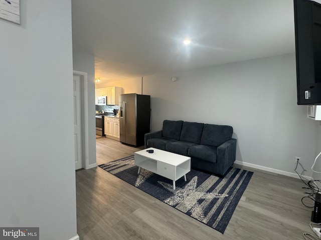 6406 Coastal Hwy Unit 201, Ocean City, MD 21842 - living area with light wood-type flooring and baseboards
