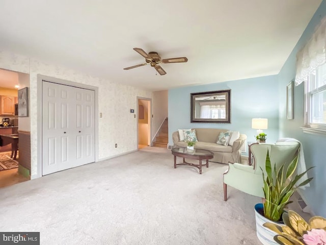 carpeted living room featuring ceiling fan