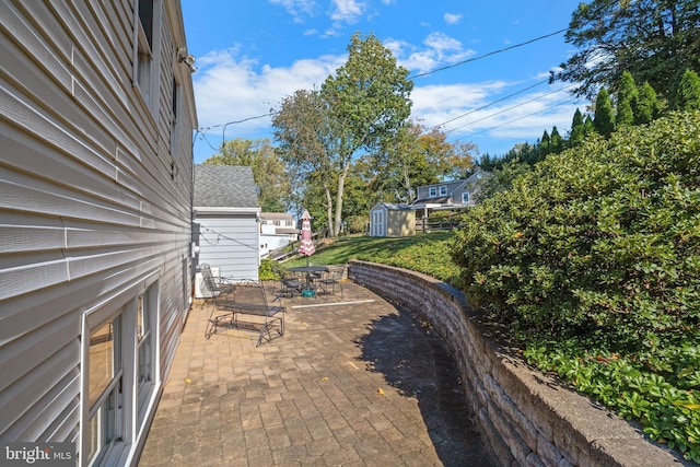 view of patio / terrace featuring a storage shed